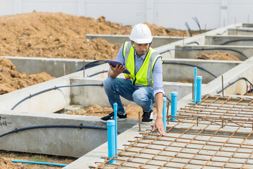 Asian construction engineer, Japanese builder worker male working inspecting footing house building.