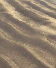Volcanic sand pattern wavy texture on the beach of  El Medano, Tenerife, Canary Islands, Spain. Abstract nature background for design.