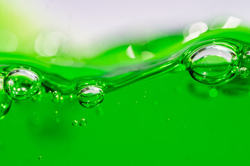 Water wave, close up of vibrant green liquid with bubbles, capturing dynamic movement and...