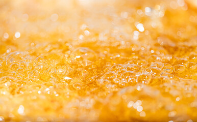 Close up bright orange Oil or beer splash texture and nature waves, Beautiful waves curve and...