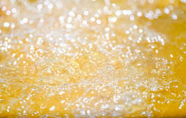 Close up bright orange Oil or beer splash texture and nature waves, Beautiful waves curve and...