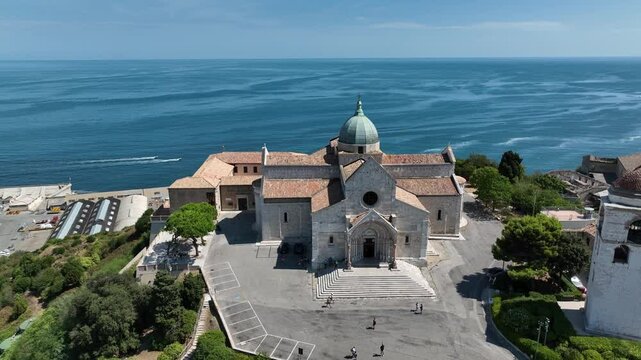 Scenic aerial view of Ancona&rsquo;s Cathedral surrounded by lush greenery and the vast Adriatic Sea. A tranquil and majestic landscape blending nature and historic heritage.