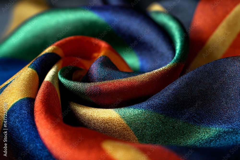 Poster Vibrant multicolored fabric displaying intricate patterns in close-up view showcasing texture and color diversity