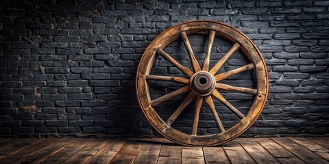 Obraz premium Old wooden wheel with rusty spokes standing alone on a black wall