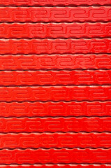 New red ornamented wooden wall closeup