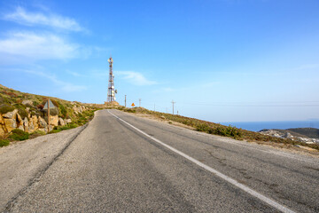 Road on Amorgos island in Greece.Telecommunications mast in background
