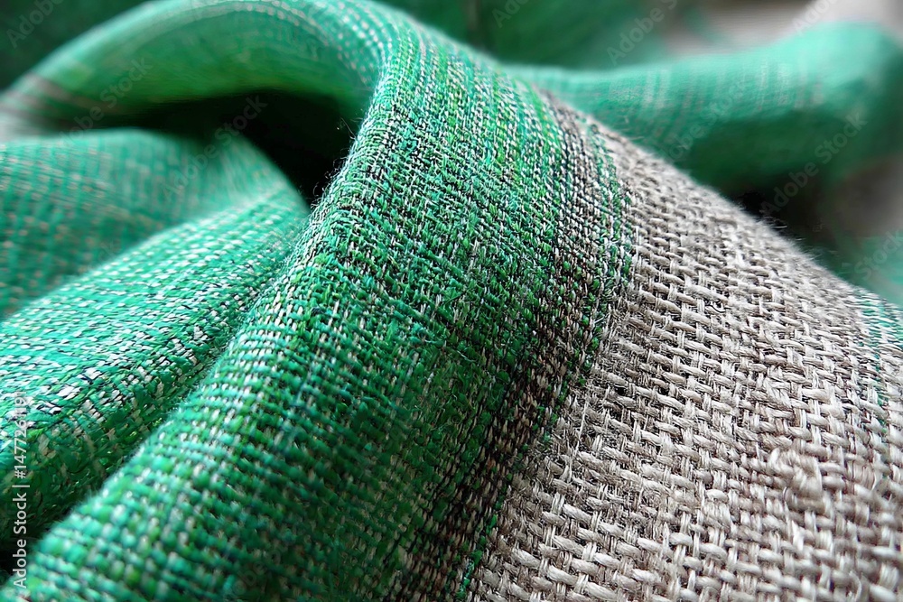 Poster close-up view of textured fabric showcasing green and beige woven patterns in natural light