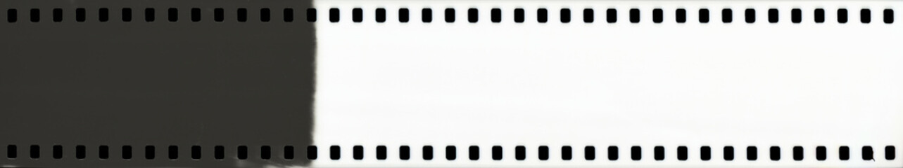 Blank 35mm film strip with perforated edges, half black and white. Ideal for vintage photography projects, film design mockups, or analog-themed creative compositions. High-resolution scan.