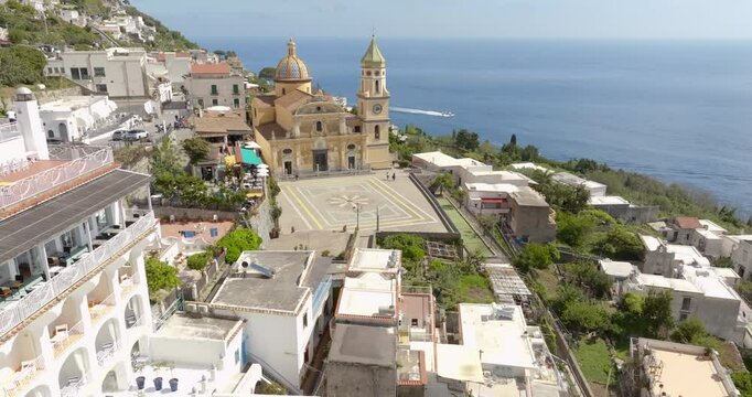 Aerial view of the church of San Gennaro in the main square of Praiano. This parish is located in the Amalfi Coast, Campania, Italy. In background is the Mediterranean Sea.