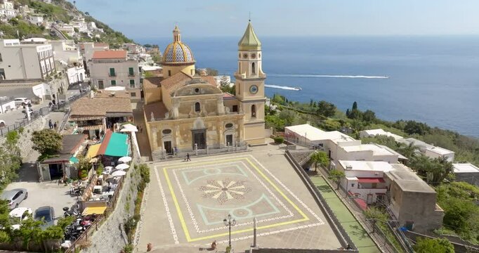 Aerial view of the church of San Gennaro in the main square of Praiano. This parish is located in the Amalfi Coast, Campania, Italy. In background is the Mediterranean Sea.