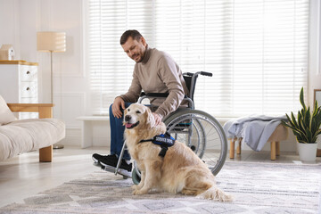 Man in wheelchair with his service dog at home