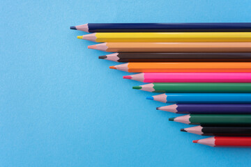Obraz premium Much colour pencils on the blue background. Space for text.