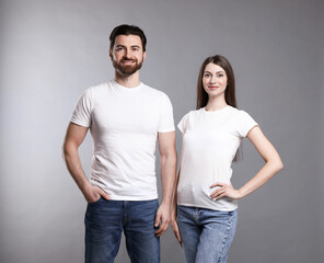 Fototapeta premium Woman and man wearing blank white t-shirts on light grey background. Mockup for design