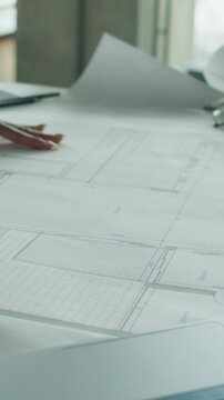 Architect works on blueprint in modern office