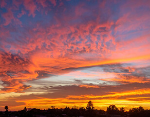 Breathtaking sunset paints sky with vibrant hues of orange, pink, and purple, creating stunning natural display