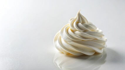 A dollop of whipped cream rests on a plain white surface, showcasing its smooth and creamy texture , culinary art