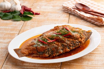 Tilapia Fish with red curry sauce,Thai Chu Chee Fish Curry in a plate.