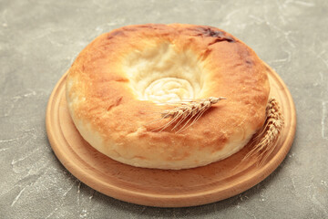 Georgian traditional bread flatbread on grey concrete background.