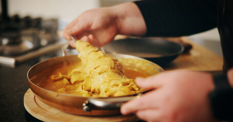 Cooking, pasta and hands in kitchen in house for health, wellness or diet dinner with recipe. Pot, chef and person with food for gourmet supper, meal or cuisine with ingredients in apartment.