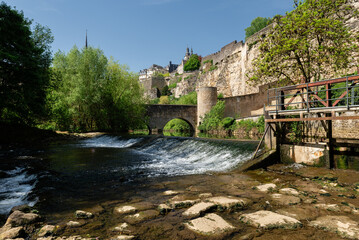 One of the sights of Luxembourg on a sunny day, with the river and the arched stone bridge.