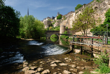 One of the sights of Luxembourg on a sunny day, with the river and the arched stone bridge.
