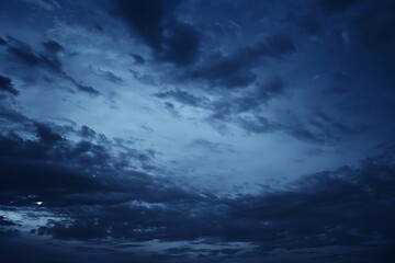 Obraz premium Dramatic Night Sky with Dark Blue Clouds and a Hint of Moonlight