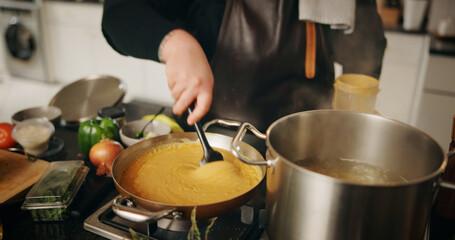 Hands, cooking and chef with pot, catering and preparation for dinner in kitchen, cuisine or restaurant. Culinary, employee and person with food for supper, hospitality or skills for gourmet in diner