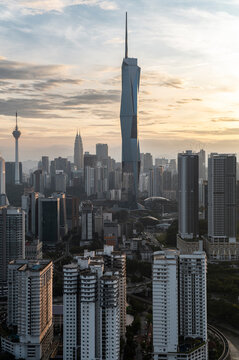 Highrise urban skyline of Kuala Lumpur with office buildings in misty morning with soft light 
