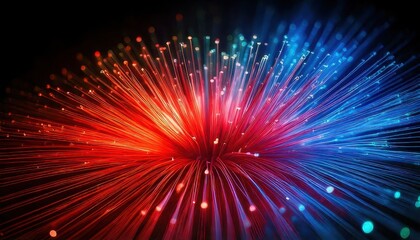 Fototapeta premium A vibrant burst of colorful fiber optic lights, glowing in red and blue on a dark background.