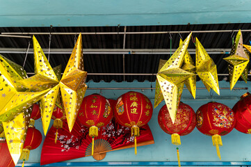 Golden stars and red Chinese lanterns hanging from ceiling in Chinatown