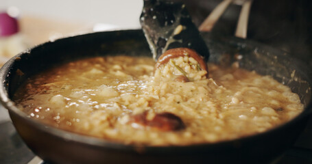Cooking, frying pan and recipe with person in kitchen of restaurant closeup for diet, health or nutrition. Food, gas stove and ingredients with chef in hotel for gourmet cuisine or hospitality