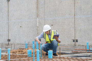 Construction site. Civil engineer. Network of pipes. Plumber. Construction engineer supervising...