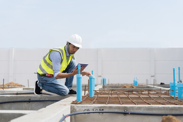 Construction site. Civil engineer. Network of pipes. Plumber. Construction engineer supervising construction work at construction site. Plumber worker working in sewer pipes area at job site