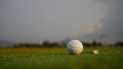 Golf balls on a green lawn in a beautiful golf course with morning sunshine.