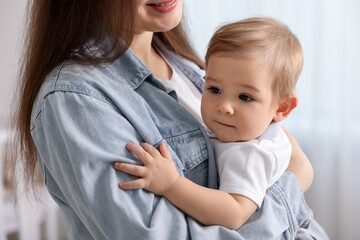 Mother with her cute little baby at home, closeup