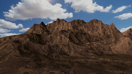 Imposing brown mountains rising under blue sky with white clouds