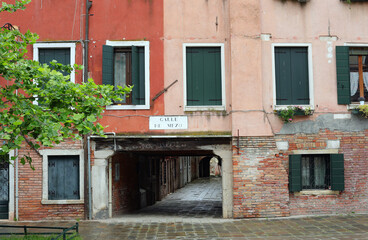 portico and houses of Venice in Italy and the name of Via CALLE DE MEZO which means the Road of Middle