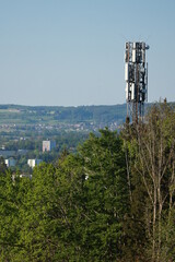 A tall tower with a lot of antennas on top of it