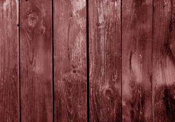 Fototapeta premium Grungy weathered red toned wooden board wall.