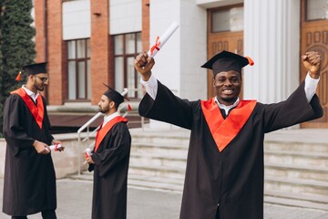 Joyful African American Graduate Holding Diploma Celebrates Graduation with Friends at University...