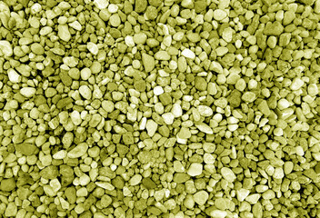 Pebble stones background. Yellow toned.