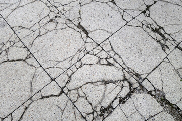 Weathered and cracked pedestrian walkway in bad condition.