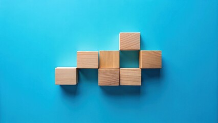 Obraz premium Unassembled wooden blocks arranged in a unique pattern on a vibrant blue background, showcasing potential for creative construction and strategic thinking