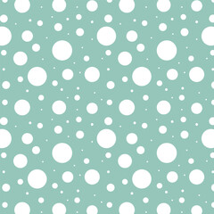 White polka dots on a colored background.Vector seamless pattern with polka dots of different sizes on a colored background.