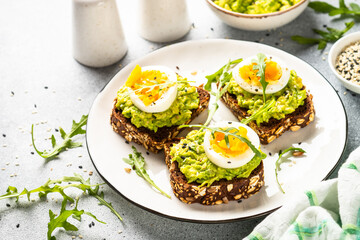 Whole grain bread with avocado and boiled eggs.