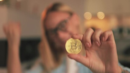 Successful businesswoman triumphantly hold golden bitcoin, expressing joy from lucrative cryptocurrency investment and professional accomplishment. Successful trading, cryptocurrency, crypto currency