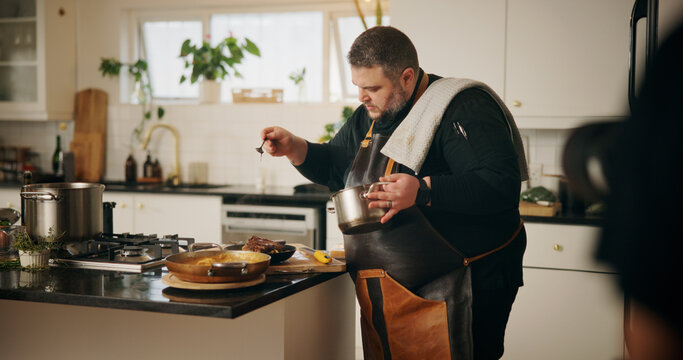 Man, chef and cooking in kitchen with food, dinner or recipe online for content creation. Camera, recording and influencer person with equipment for live streaming, diet advice and meal in home