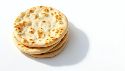 A stack of golden, freshly baked flatbreads, casting a soft shadow, a culinary delight.