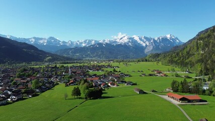 Village in alpine valley with blue sky