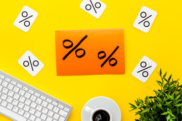 Sales and online shopping concept. Top view of a table with computer and discount percentage sing